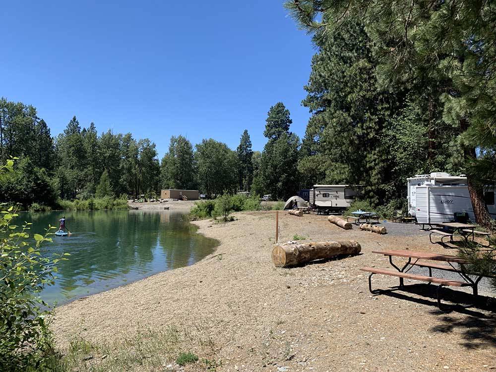 A group of campsites by the water at WHISPERING PINES RV CAMPGROUND