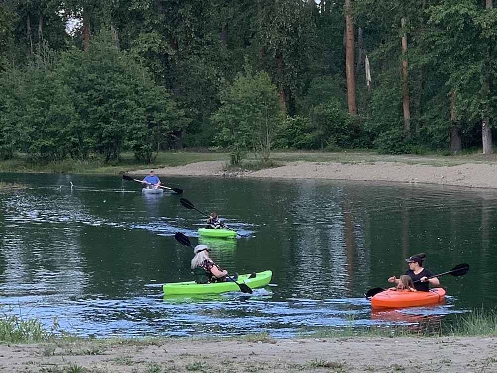 People kayaking on the water at WHISPERING PINES RV CAMPGROUND