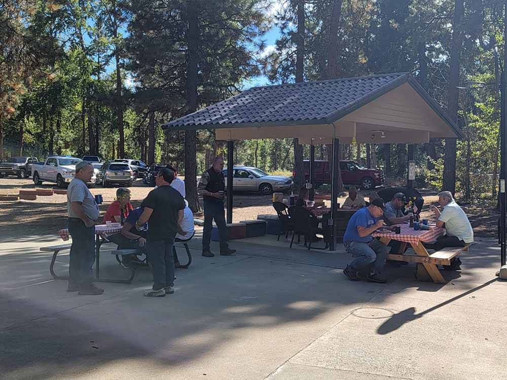 A group of people eating at WHISPERING PINES RV CAMPGROUND