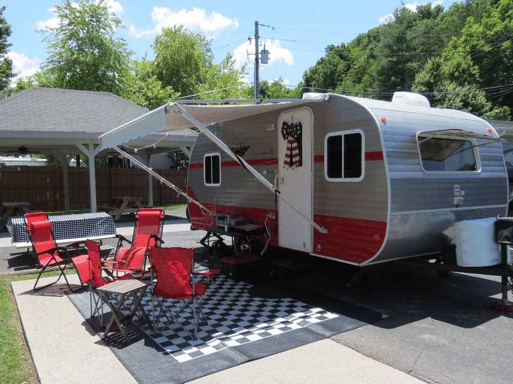 A travel trailer set up for camping at CREEKSIDE RV PARK
