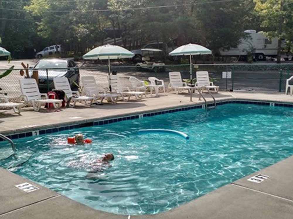 People in the swimming pool at SMOKY BEAR CAMPGROUND AND RV PARK