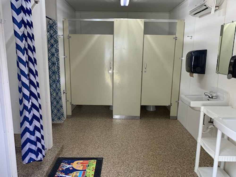 Bathroom with showers and stalls at KELLOGG RV PARK
