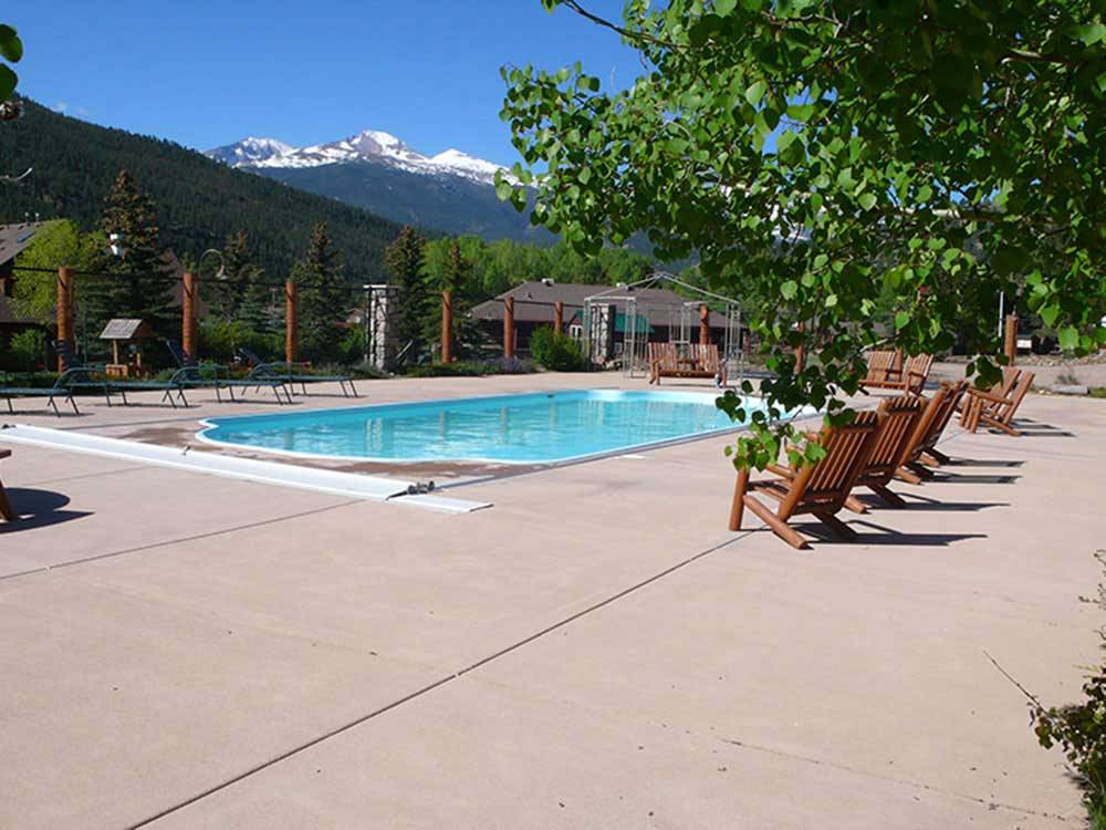 Swimming pool with outdoor seating at ELK MEADOW LODGE AND RV RESORT