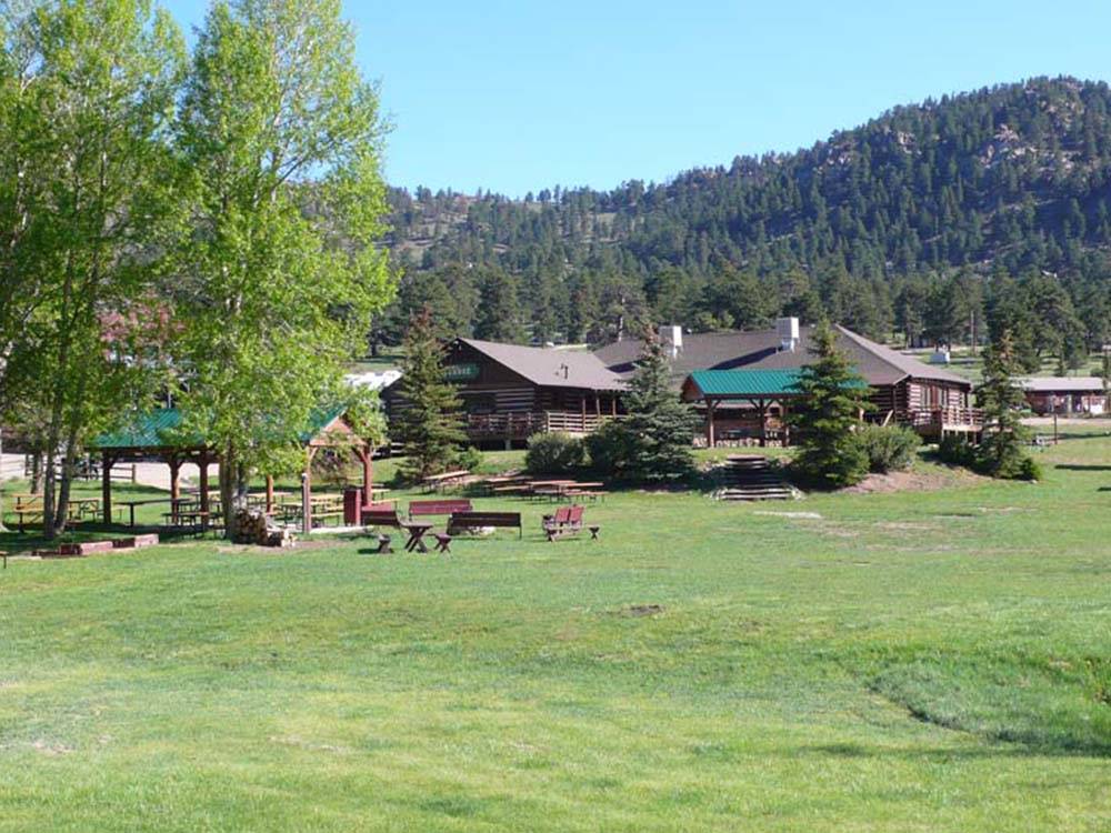 A cluster of campground buildings on a sprawling green space at ELK MEADOW LODGE AND RV RESORT
