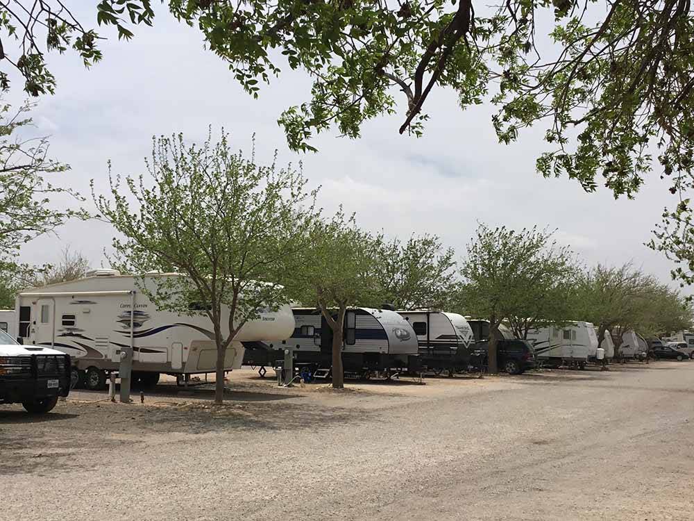 A row of gravel RV sites at MIDLAND RV CAMPGROUND