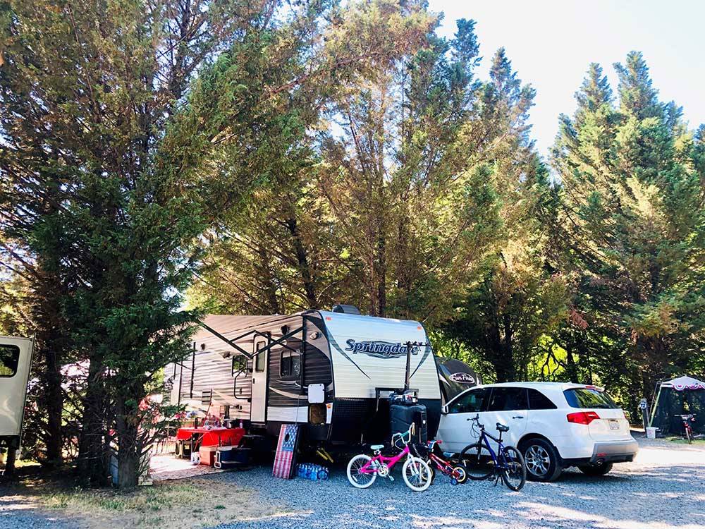 A travel trailer parked on-site at RIVER BEND RESORT