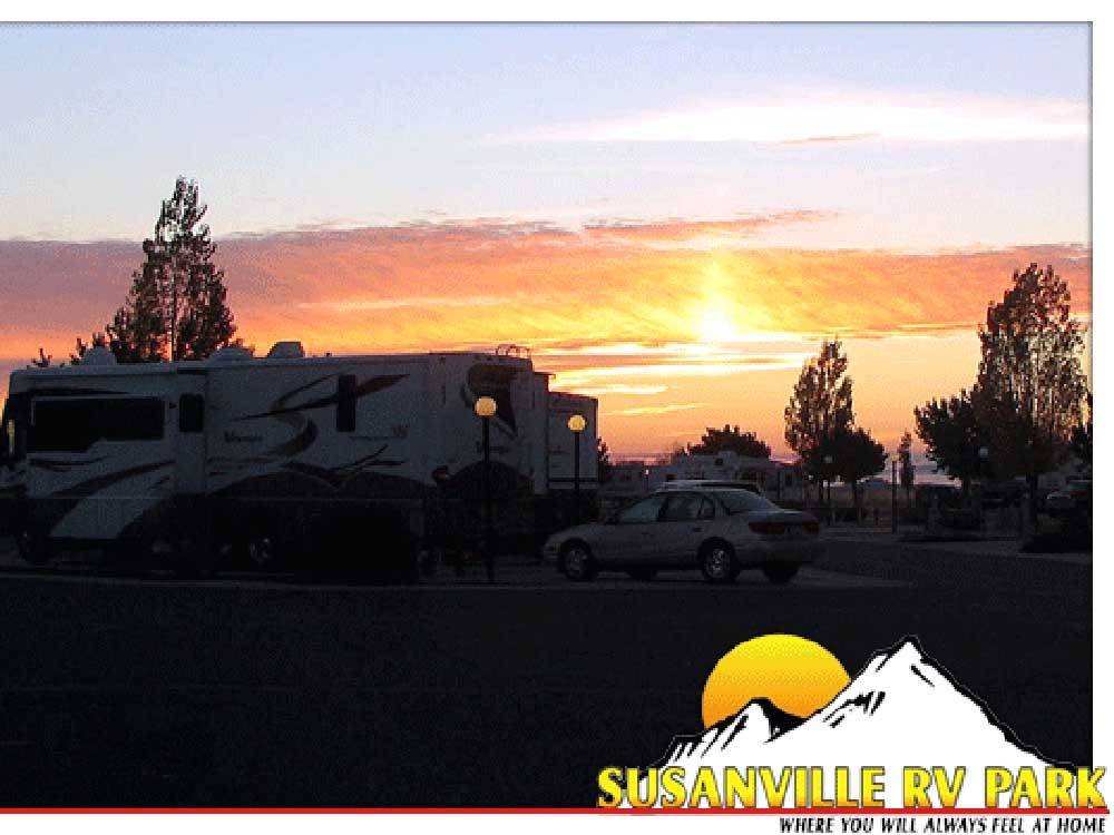 RV sites with the sun setting in the background at SUSANVILLE RV PARK