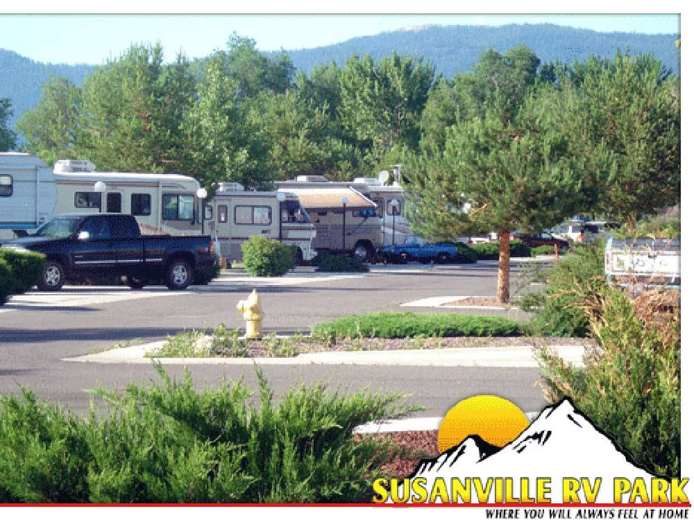 A row of RVs, a truck and sports car at SUSANVILLE RV PARK