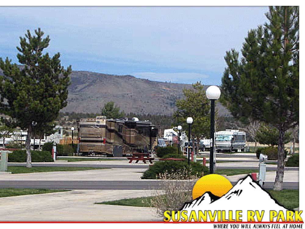 Paved sites and roads with hills in the distance at SUSANVILLE RV PARK