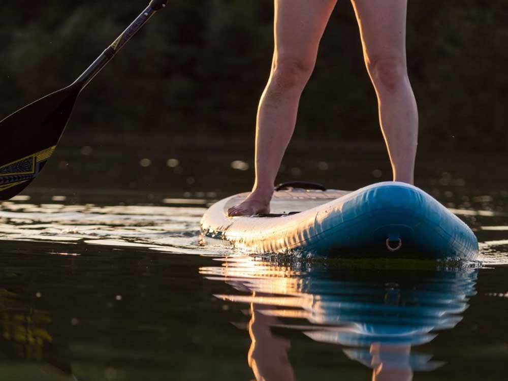 A person on a standing paddle board at HTR TX HILL COUNTRY