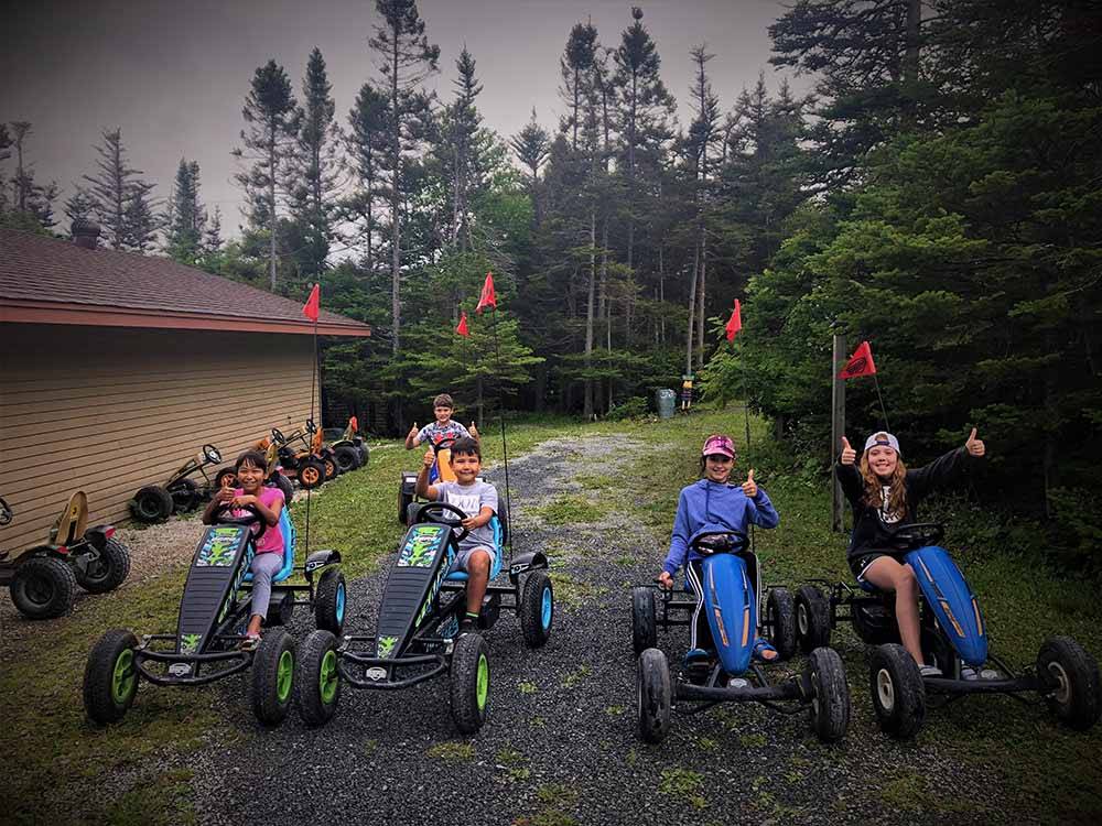 A group of kids riding pedal cars at GROS MORNE/NORRIS POINT KOA