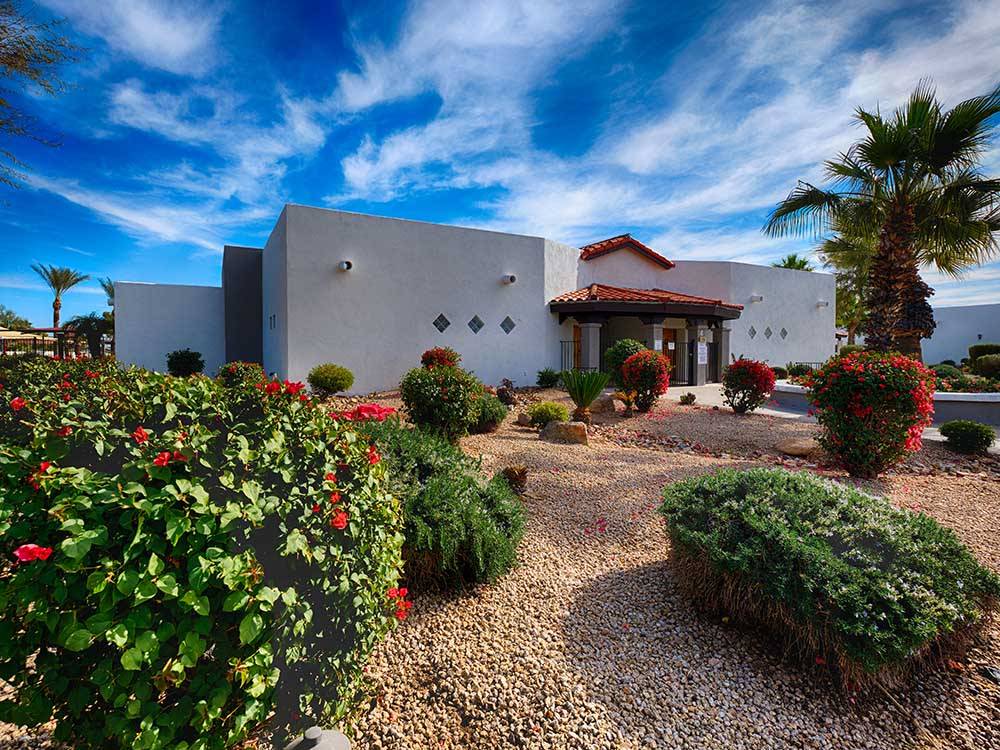 Main building with beautiful landscaping in foreground at PUEBLO EL MIRAGE RV & GOLF RESORT