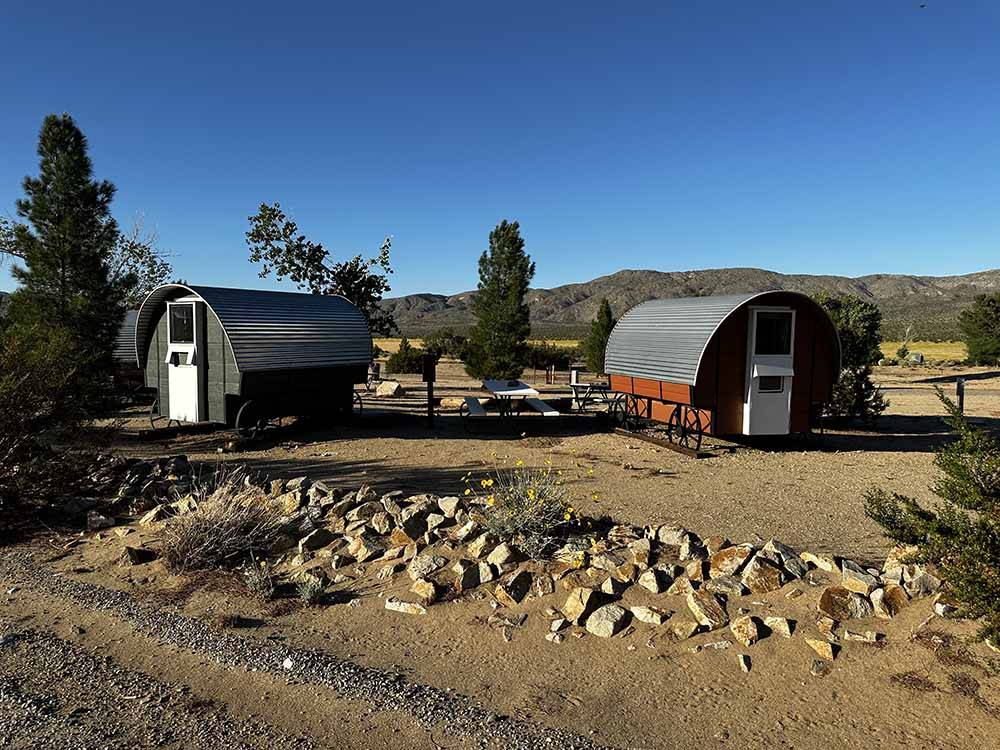 Two wooden and metal wagon rentals at STAGECOACH TRAILS RV PARK