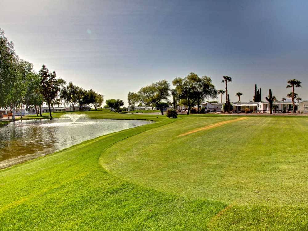 Wide view of resort grounds with water fountain at GOLD CANYON RV & GOLF RESORT