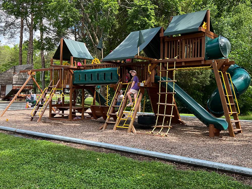 The wooden playground equipment at COZY ACRES CAMPGROUND/RV PARK