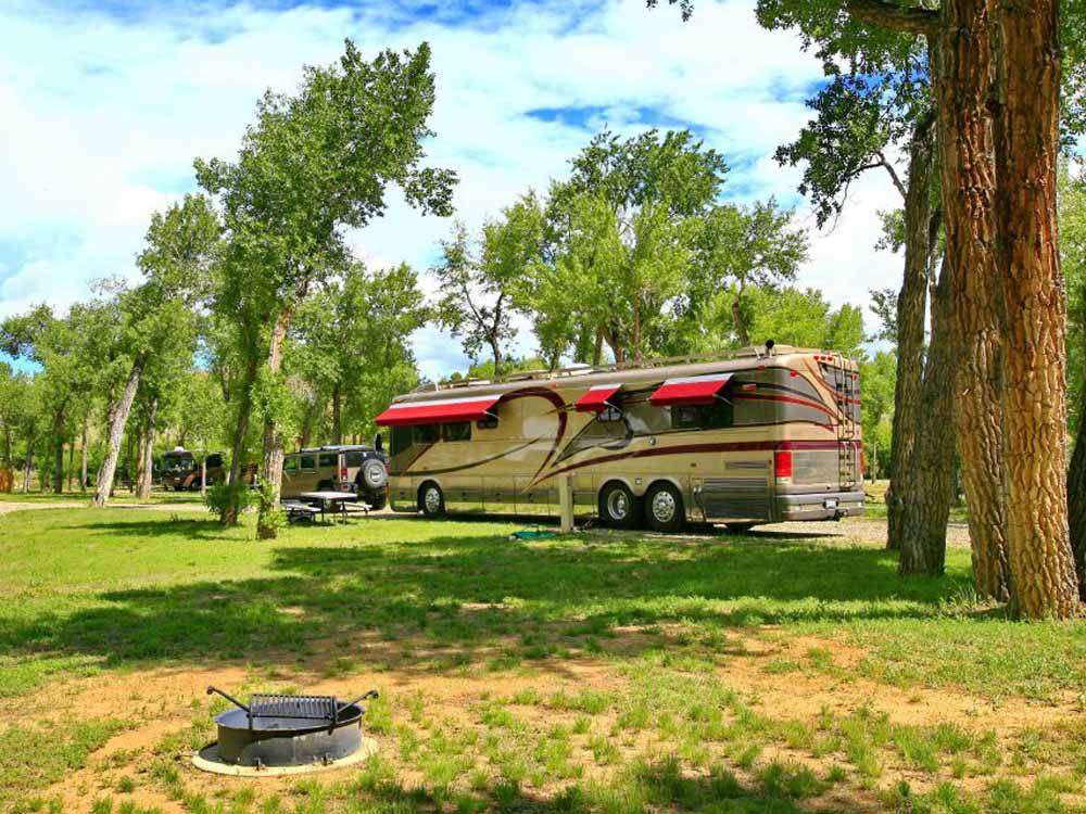 A Class A motorhome parked in an RV site at THE LONGHORN RANCH LODGE AND RV RESORT