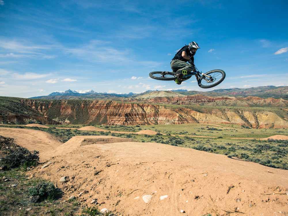 A person jumping on a mountain bike at THE LONGHORN RANCH LODGE AND RV RESORT