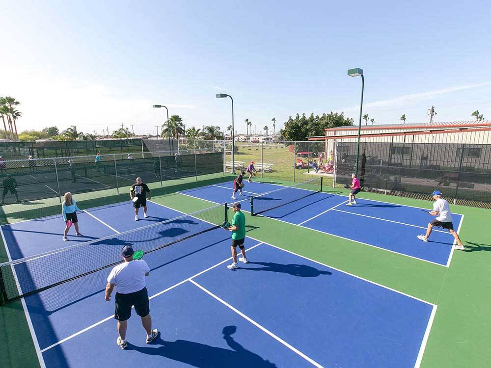 People playing tennis at ENCORE TROPIC WINDS