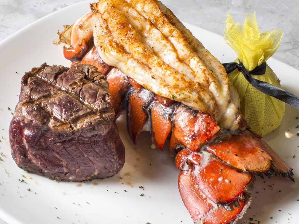 A plate of steak and lobster at COUSHATTA LUXURY RV RESORT AT RED SHOES PARK