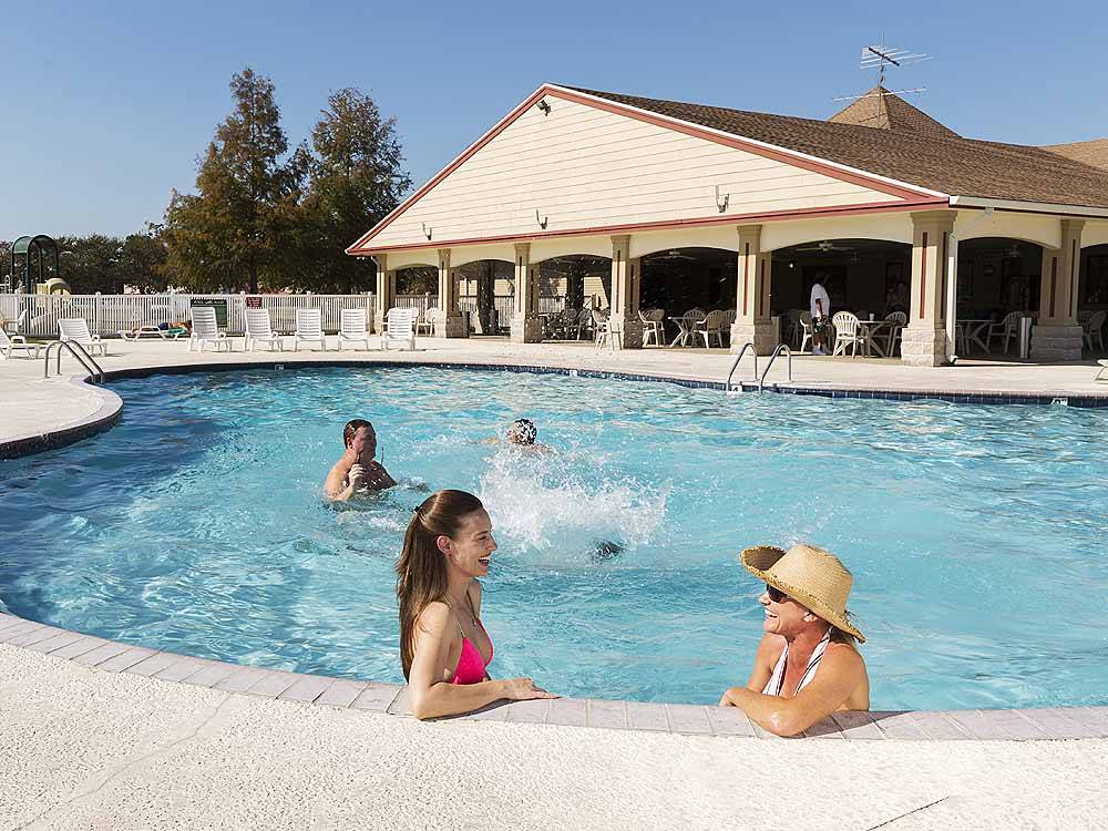 People playing in the pool at COUSHATTA LUXURY RV RESORT AT RED SHOES PARK