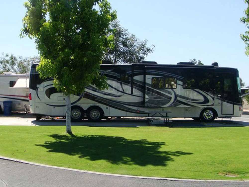 Black, white and grey motorhome parked at A COUNTRY RV PARK