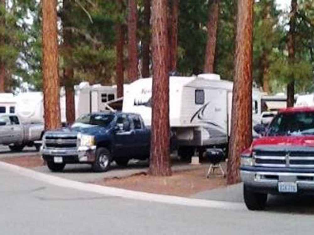 Row of RV trailers in campsites at EAGLE LAKE RV PARK
