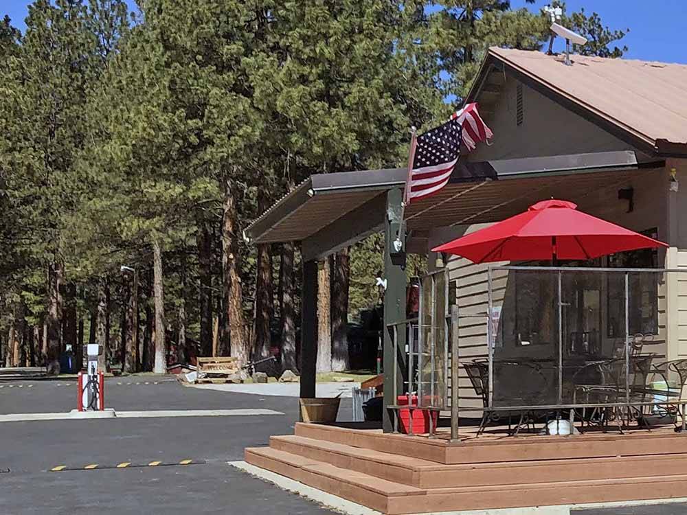 Building patio with American flag flying at EAGLE LAKE RV PARK