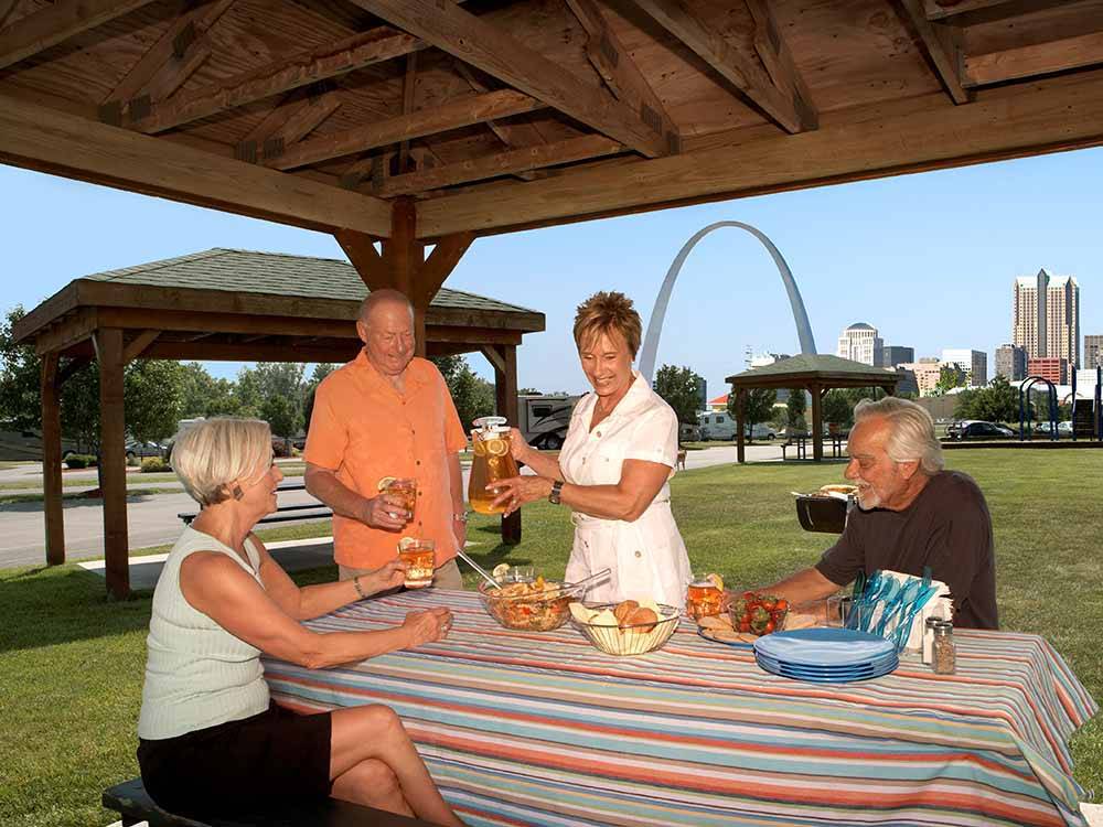 People eating at a picnic table at DRAFTKINGS AT CASINO QUEEN RV PARK