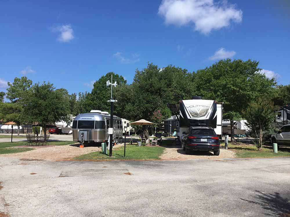 Airstream and fifth-wheel in neighboring sites at WOODLAND LAKES RV PARK