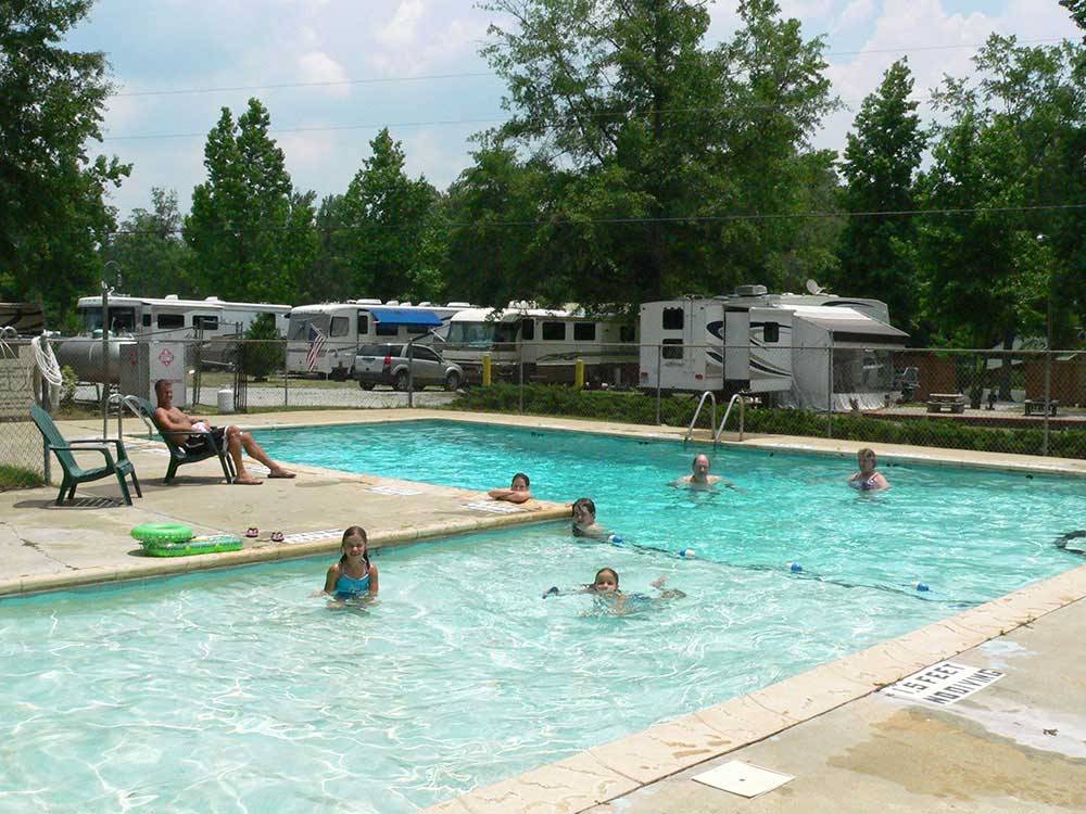 People swimming in the pool at LAKE PINES RV PARK & CAMPGROUND