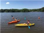 Man and woman in kayaks on the lake at LAKE GASTON AMERICAMPS - thumbnail