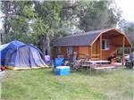 Log Cabin with tents and picnic table at DEER PARK - thumbnail