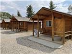 Row of wooden guest cabins at PONDEROSA CAMPGROUND - thumbnail
