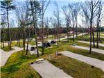 Concrete pads surrounded by grass and autumn trees at PINE LAKE RV RESORT & COTTAGES - thumbnail