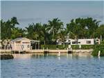 Little pink boathouse on lake with motorhomes nearby at BOYD'S KEY WEST CAMPGROUND - thumbnail
