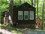 Log cabin in shaded area at MISTY MOUNTAIN CAMP RESORT - thumbnail