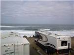 RVs camping at ocean with crashing waves at SEA & SAND RV PARK - thumbnail