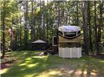  A fifth wheel trailer parked in a wooded RV site at WAKEDA CAMPGROUND - thumbnail