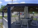 A covered gazebo with outdoor chairs at KISSIMMEE RV PARK - thumbnail
