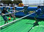 Kids playing in a human foosball game at CAMPLAND ON THE BAY - thumbnail