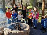 People standing around a fire pit at STONEBRIDGE RV RESORT - thumbnail