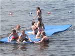 Kids swimming in lake at LAKE DUBAY SHORES CAMPGROUND - thumbnail