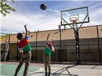 Two boys playing basketball at SALT LAKE CITY KOA - thumbnail