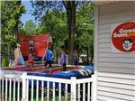 Kids playing on a colorful jumping pillow at CAMP A WAY RV PARK - thumbnail