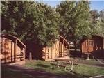 Log cabins at campground at HAPPY HOLIDAY RV RESORT - thumbnail