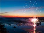 Fireworks show with sunset in the back at WAFFLE FARM CAMPGROUNDS - thumbnail