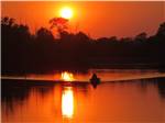 A couple in a boat at sunset at WAFFLE FARM CAMPGROUNDS - thumbnail