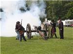 Men firing a cannon at the battlefield at GETTYSBURG CAMPGROUND - thumbnail