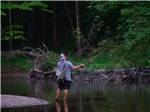 Angler casts his line in serene pond at GETTYSBURG CAMPGROUND - thumbnail