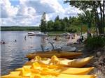 Yellow kayaks and boats on the lake at PATTEN POND CAMPING RESORT - thumbnail